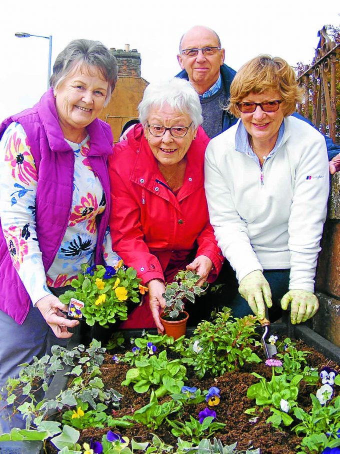 FLOWER POWER . . . left to right: Marion Stewart, Janet Johnstone and Jeff and Fiona Evans are encouraging community-minded people to adopt flower tubs in the centre of Annan