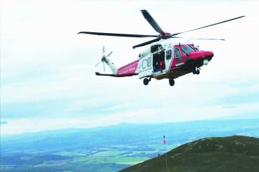 Walker in hill helicopter rescue